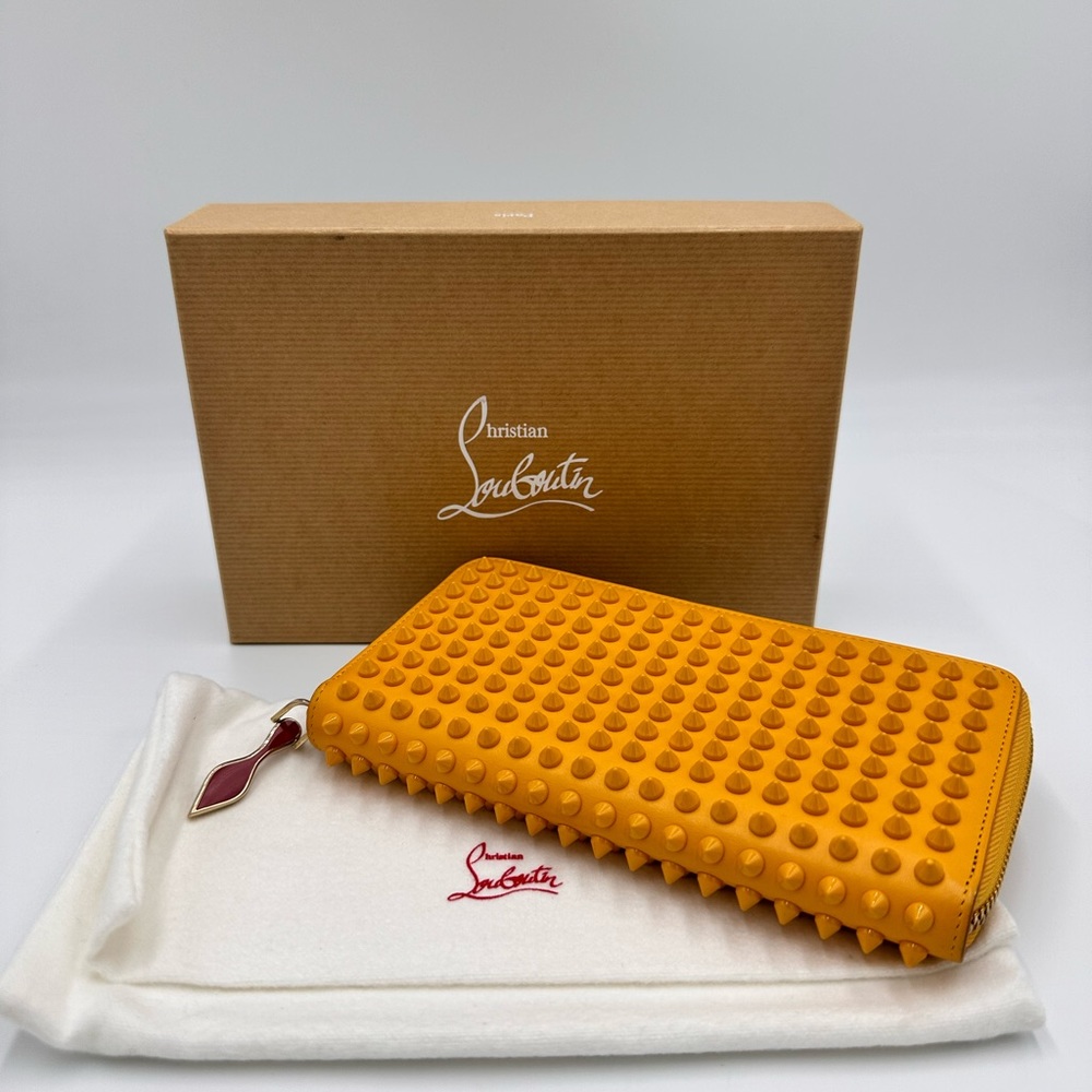 CHRISTIAN LOUBOUTIN
Calfskin Panettone Spiked Zip Around
Wallet Dark Yellow